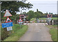 TM0464 : Level crossing with train due by Andrew Hill