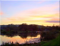 SU0625 : Sunset over the fishing lakes in Bishopstone by Maigheach-gheal