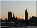 TQ3079 : Westminster: a plane passing over the Houses of Parliament by Chris Downer