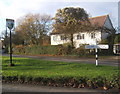 TM0246 : House, lane junction and village sign, Whatfield by Andrew Hill