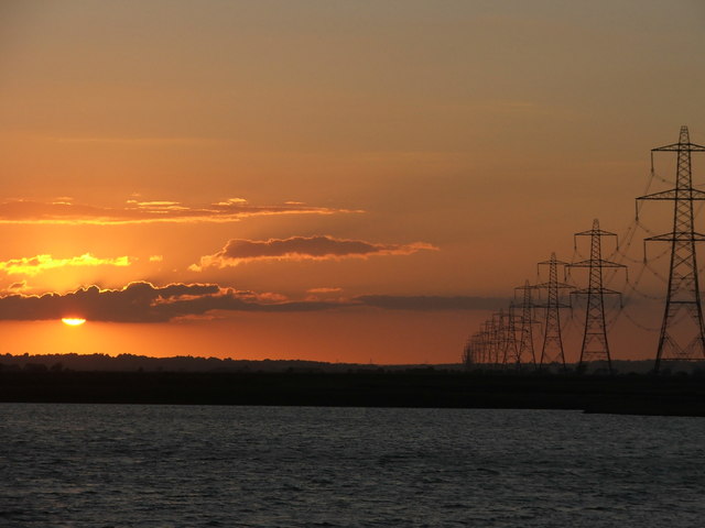 Pylons sweeping away from Dungeness towards the sunset