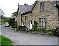 Cottages on green adjacent to A684