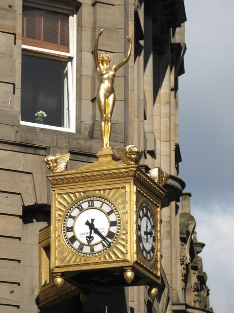 Golden naked woman; and clock
