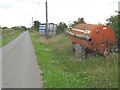 Farm machinery along the edge of the lane