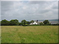 Path across a meadow to a bridge over the former railway line