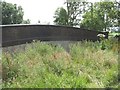 A railway footbridge over a now infilled cutting