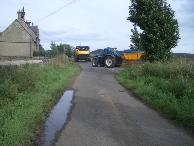 Farm machinery leaving Crosshill Farm road at High Houses
