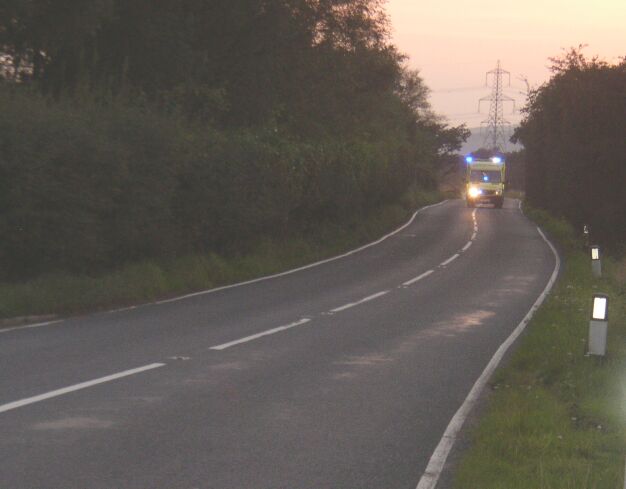 Emergency vehicle travelling on  B4280 at sunset