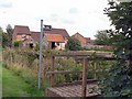 Paddock and footbridge on edge of housing estate at Holdingham