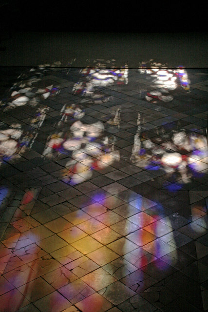 Stained glass sunlight on tiled floor