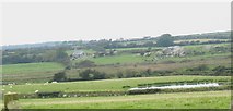 SH3879 : View across marshland and rocks towards Llandrygan Church by Eric Jones
