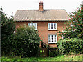 A pair of red-brick cottages