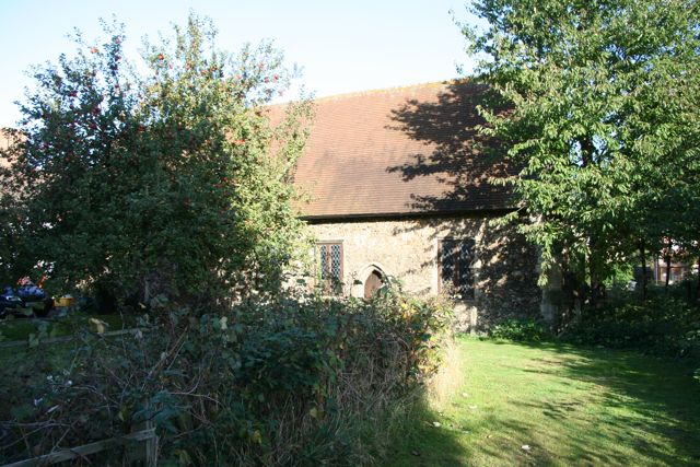 Duxford Chapel, hemmed in by trees and bushes